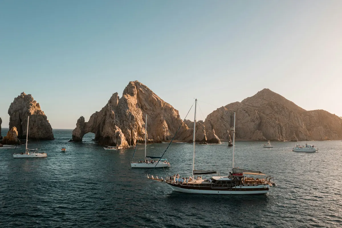 Sailboats anchored beside the arch at Land's End, Cabo San Lucas